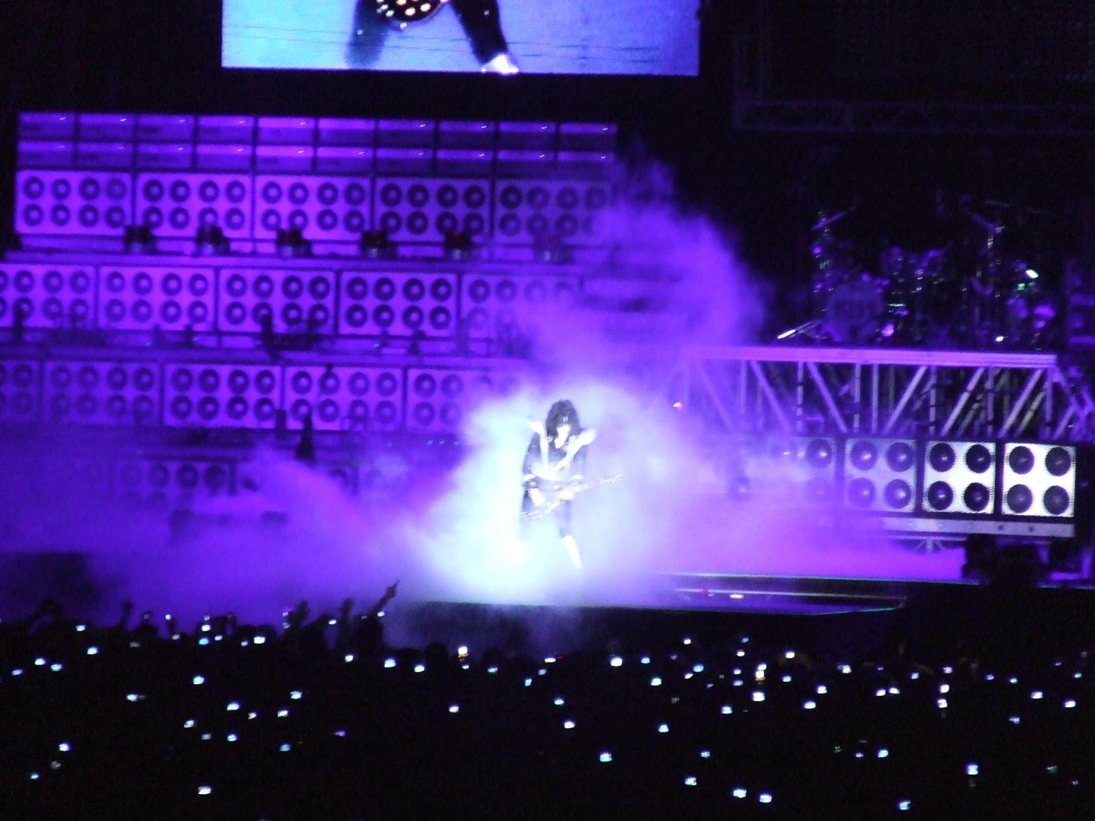 a person standing on top of a stage surrounded by smoke