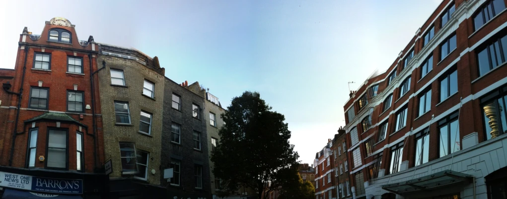 many tall buildings line the street with small shops