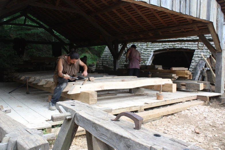 a man works on a piece of wood