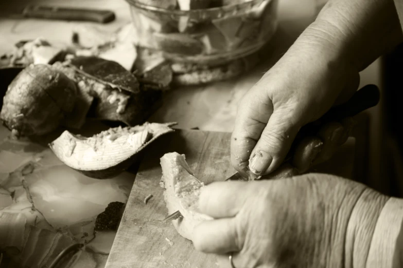 a man is preparing bread on a  board