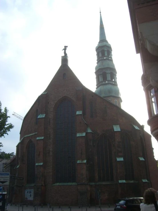 an old building with tall towers and a cross in the front