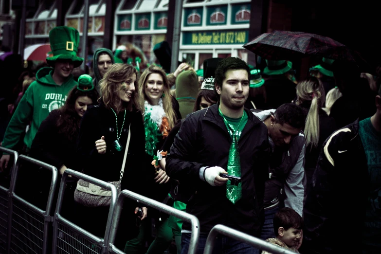 a group of people with green and black outfits