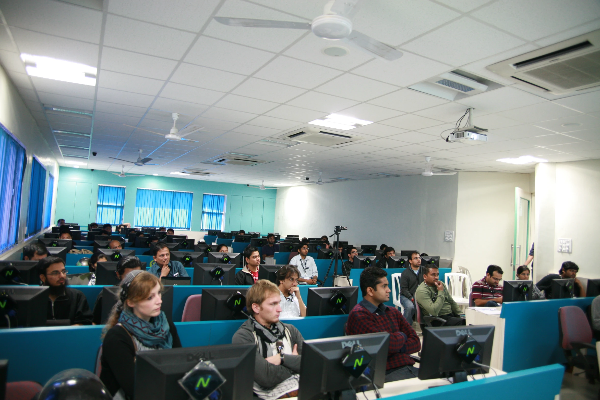 people sitting in rows looking at computer screens