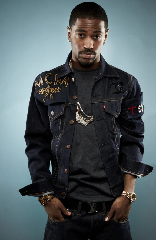 a young man with black hair wearing a denim jacket