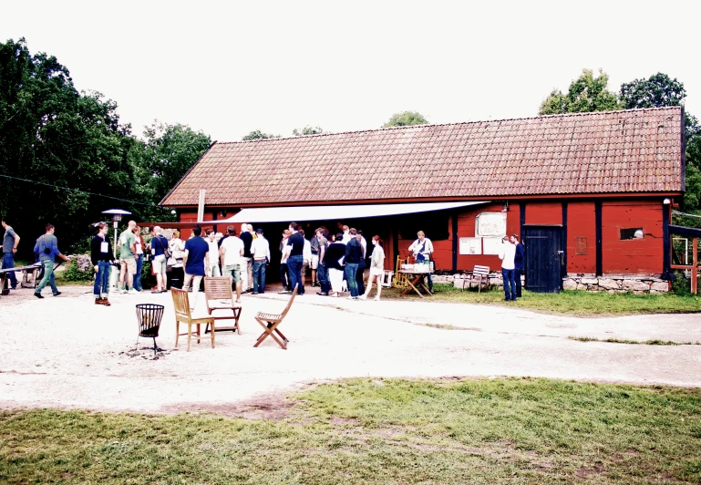 people at a barn looking through a door to another barn