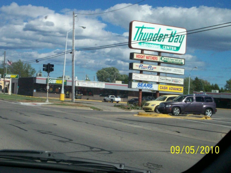 a restaurant with two cars parked in front of it