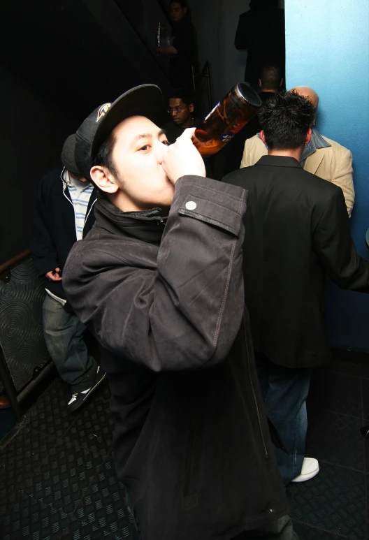 there is a young man drinking from a bottle