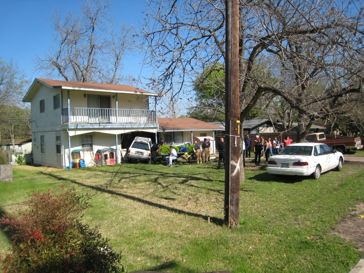 a group of people standing in front of a house