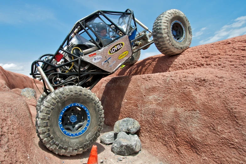 a large truck is on the rocks over a carrot