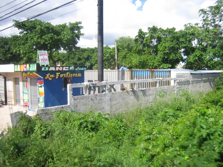 a fenced off area with various store fronts