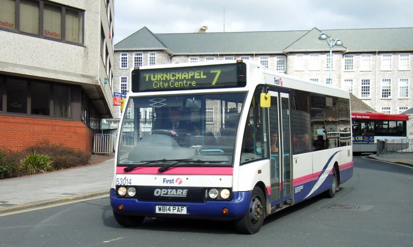 a passenger bus that is traveling down the street