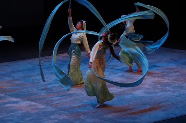 the two young women are performing a dance on stage