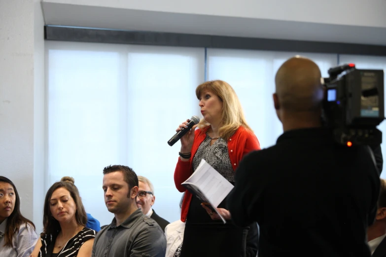 people in front of a television and a microphone