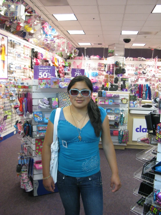 a woman standing in a store with items on display