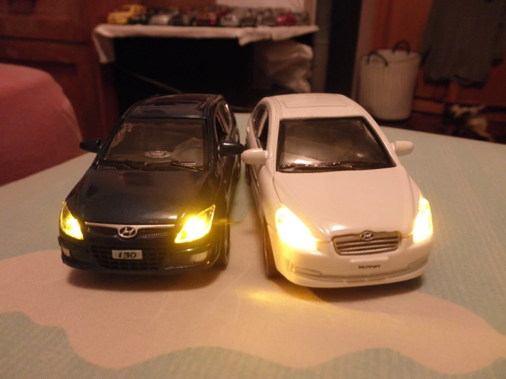 two toy cars parked on top of each other