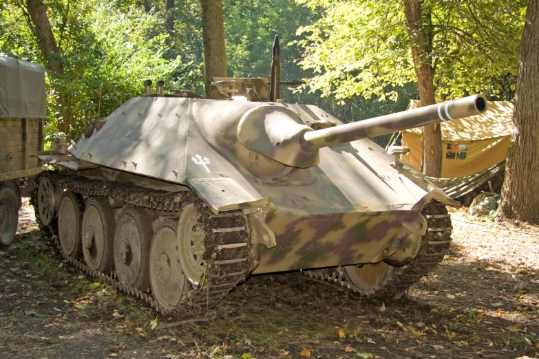 this tank is sitting on the ground in the woods