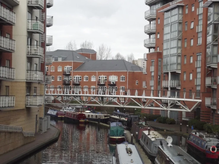 several boats are docked in the water along a waterway