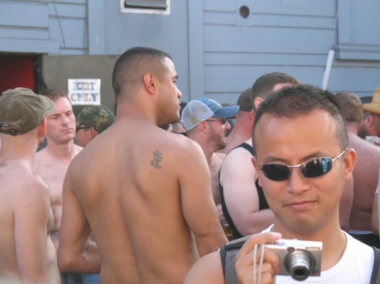 a group of shirtless men standing around each other