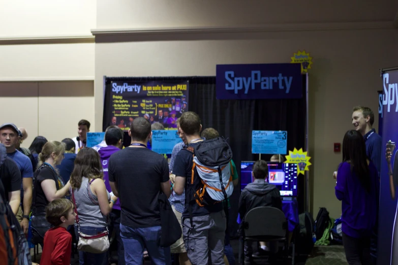 a group of people stand in front of a poster