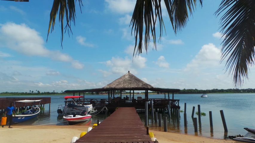 the pier on a beach with several boats docked in the water