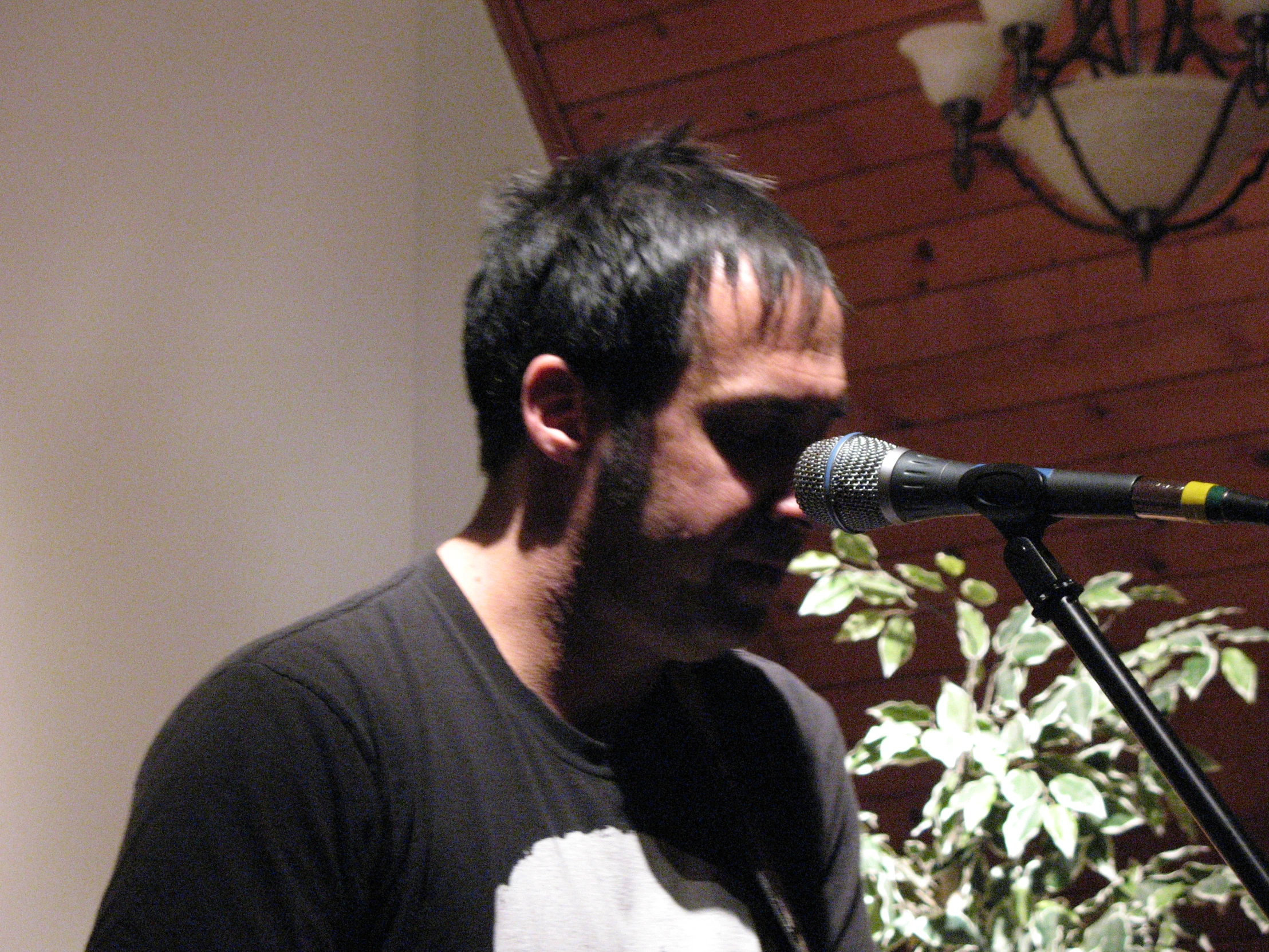 a man is playing an instrument in front of a microphone