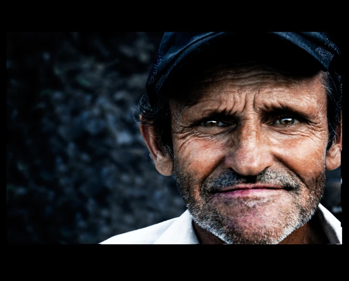 this man is wearing a hat and is smiling