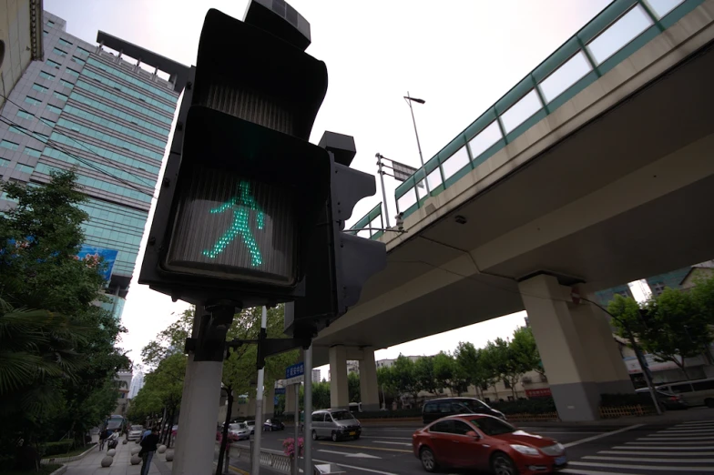 a green walk crossing sign mounted to a traffic light