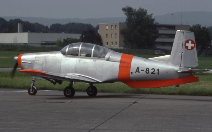a fighter plane with a red cross painted on the side