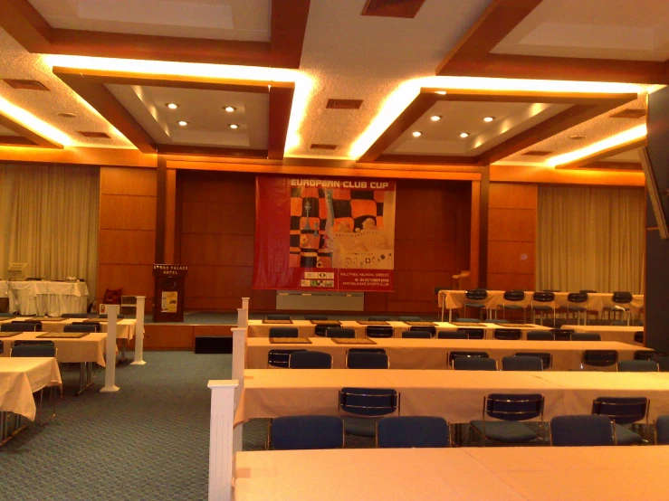 a view of a class room with tables and chairs