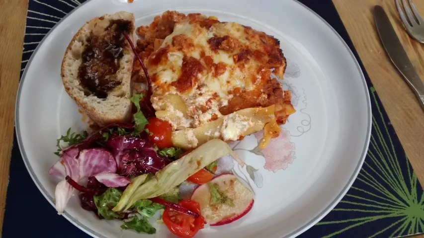 the plate has some pasta and bread on it