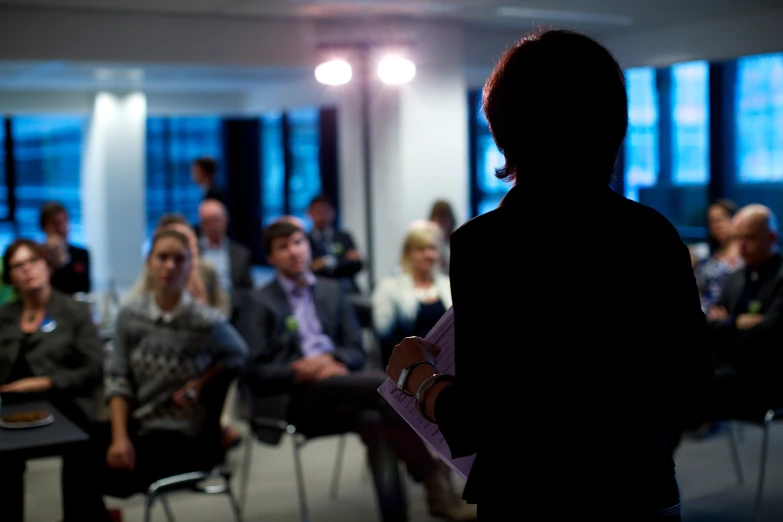 a crowd of people are standing in an empty room