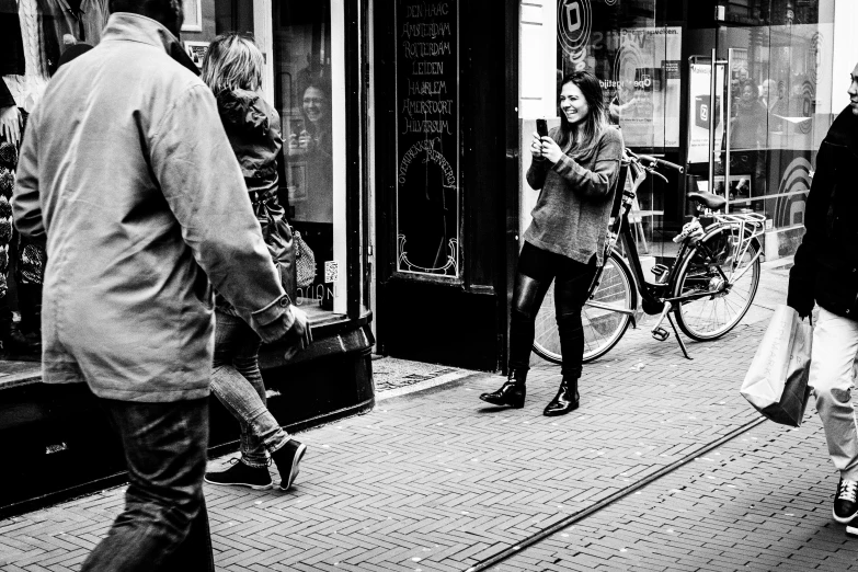 people walking down the sidewalk outside a building