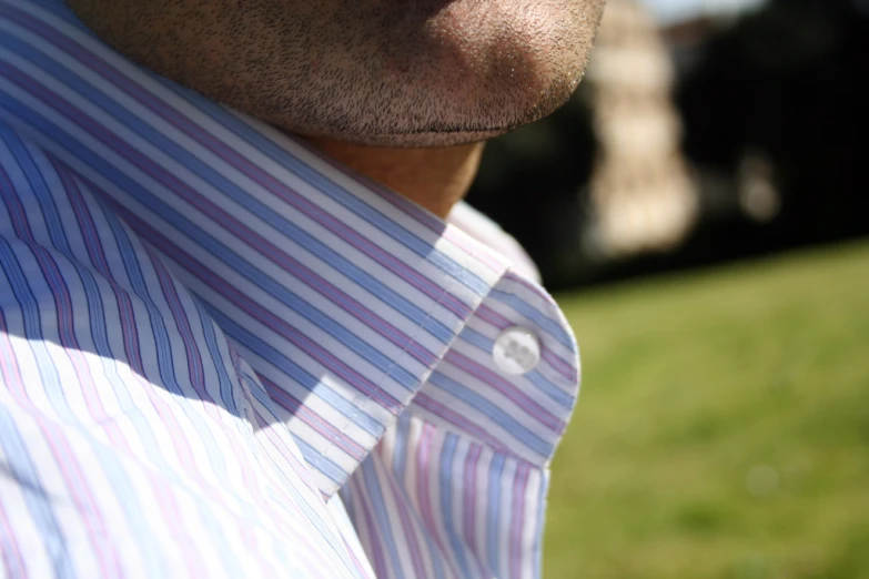 a man wearing a tie looking down at his left shoulder