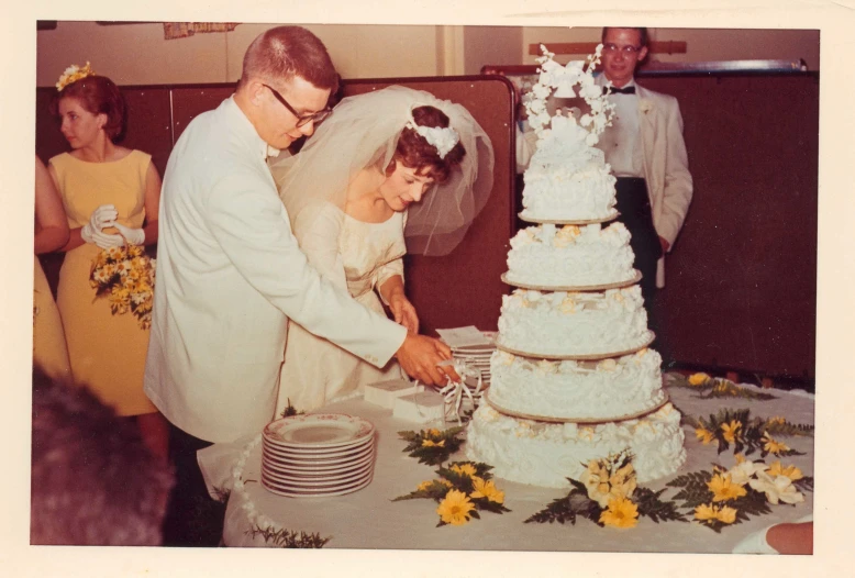 two people  a large white cake