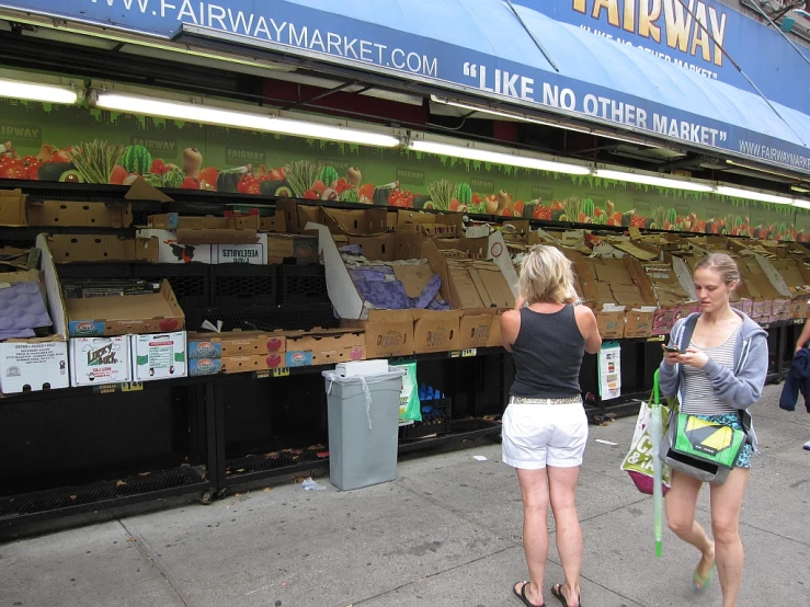 a few women that are walking on a sidewalk