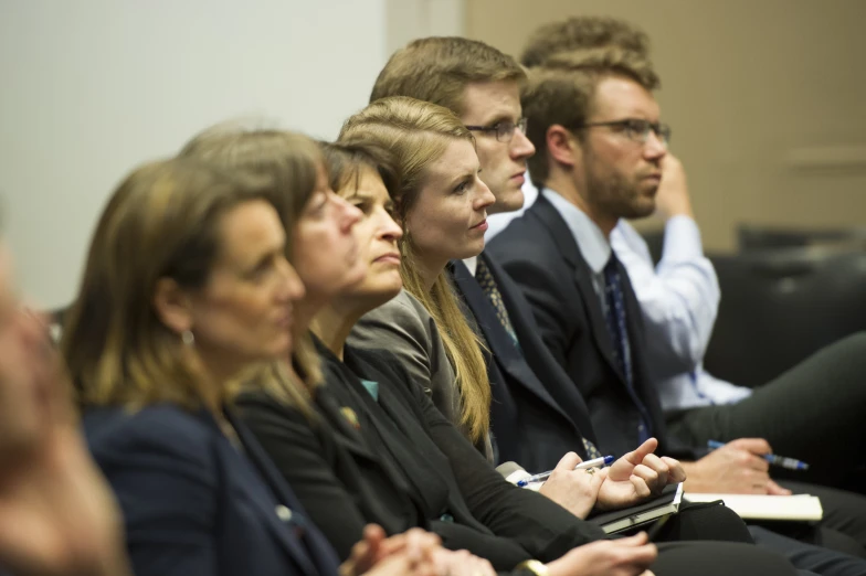 people sitting and facing in different directions at a presentation