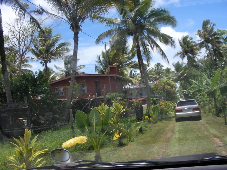 a car parked on the side of the road in front of a house