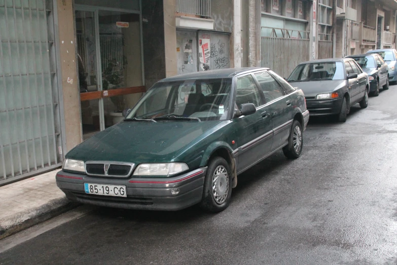 three cars parked in the same line on a city street