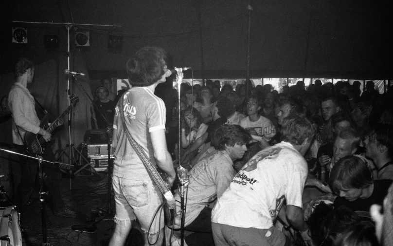 band members playing and singing on stage in front of a crowd