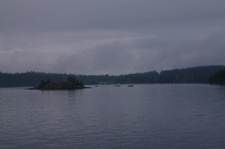 a small island is surrounded by water and trees