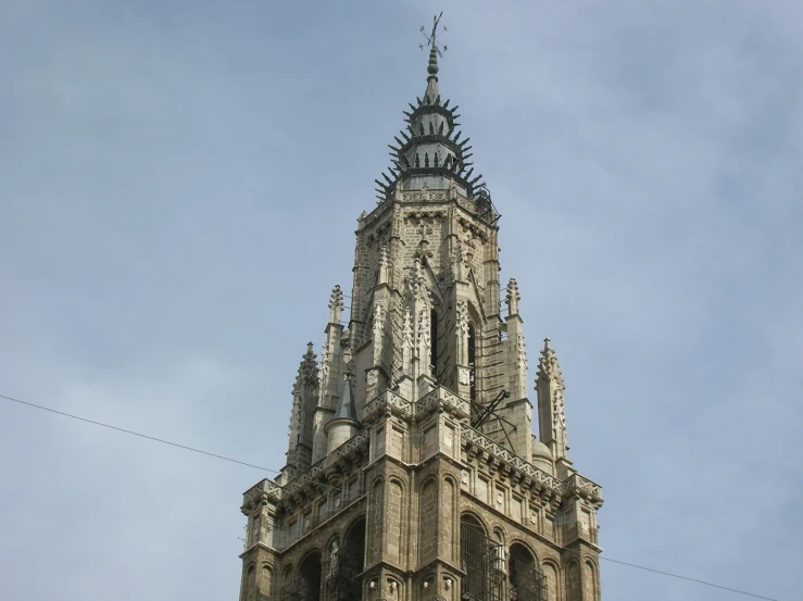 a large building with a tall spire that has a clock on it