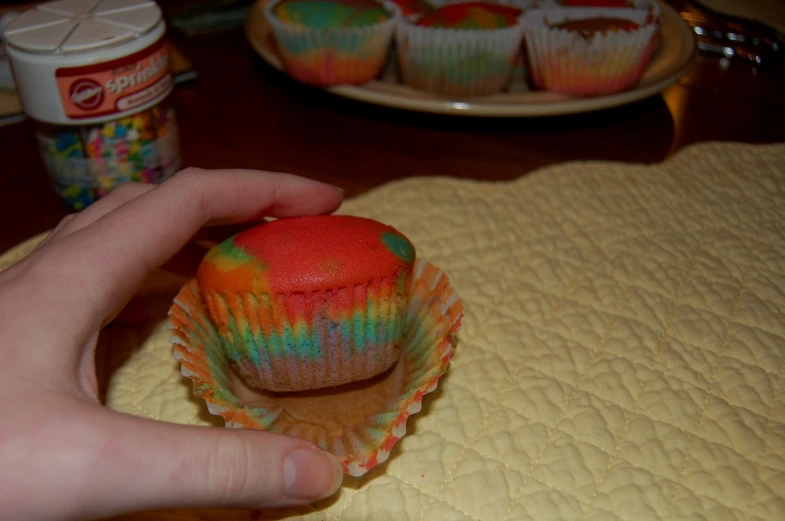 a colorful cupcake with red frosting and blue icing