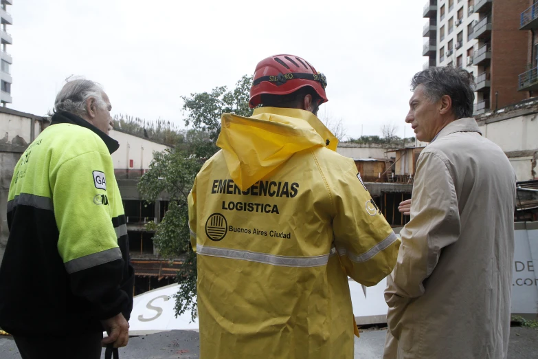 three men wearing rain jackets and wearing hats