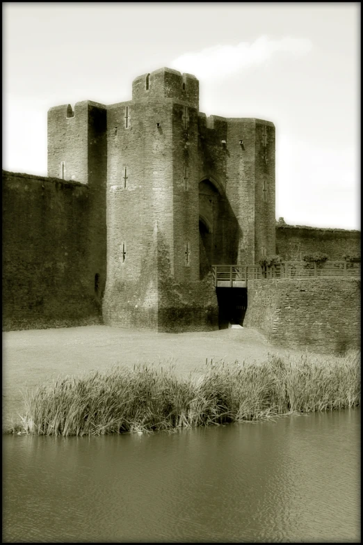 an old stone building on the side of a river