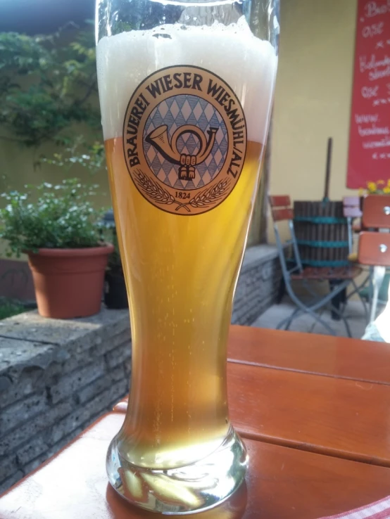 a glass sitting on top of a wooden table