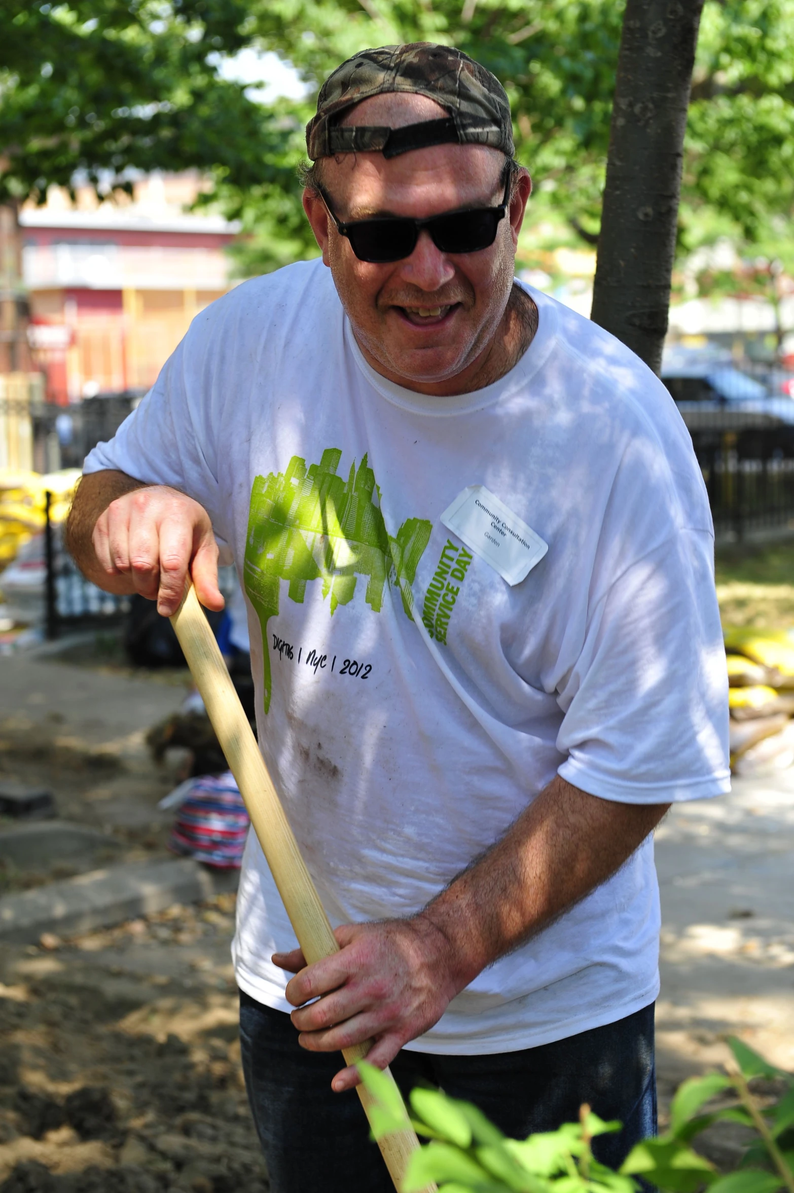 an older man with sunglasses holding a baseball bat