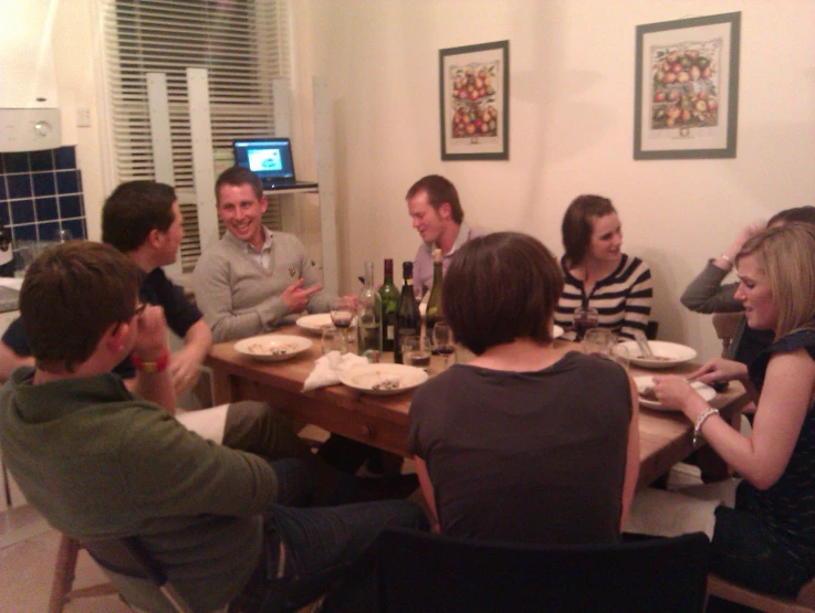 many people are gathered at the table for dinner