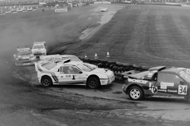 two car heads over a truck on a track