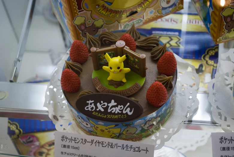 a pokemon cake is decorated with fruits and other stuff