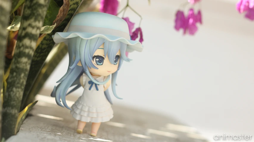 a toy figurine is standing by a flower